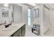 Clean bathroom features a vanity with storage, a decorative mirror, and a shower curtain at 9143 San Ambrosio, Orlando, FL 32836