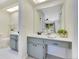 Bright bathroom with vanity, white tile floor, and decorative accents at 9143 San Ambrosio, Orlando, FL 32836