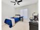 Bedroom with a ceiling fan, a window, and a blue bed with a patterned throw at 9143 San Ambrosio, Orlando, FL 32836