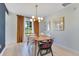 Bright dining room features modern lighting, gold accents, and views of the lake at 9143 San Ambrosio, Orlando, FL 32836