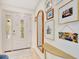 Bright foyer featuring decorative glass door, wood floors, a charming mirror, and stylish decor at 9143 San Ambrosio, Orlando, FL 32836