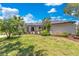 Beautiful single-story home with a well-maintained lawn, mature trees and a covered front entryway at 9143 San Ambrosio, Orlando, FL 32836