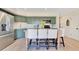 Bright kitchen with green cabinets, stainless appliances, and a wooden island at 9143 San Ambrosio, Orlando, FL 32836