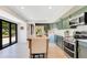 Bright kitchen featuring shaker cabinets, stainless appliances, and black framed glass doors at 9143 San Ambrosio, Orlando, FL 32836
