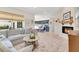 Relaxing living room showcasing a fireplace, sectional sofa, rug, and bright kitchen at 9143 San Ambrosio, Orlando, FL 32836