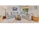 Bright living room featuring a large sectional sofa, area rug, and view to the outside at 9143 San Ambrosio, Orlando, FL 32836