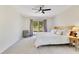Comfortable bedroom with a wooden bed frame, ceiling fan, and bright windows at 9143 San Ambrosio, Orlando, FL 32836