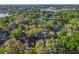 Scenic aerial shot showcasing a residential area with mature trees and a tranquil lake at 998 Piedmont Oaks Dr, Apopka, FL 32703