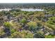 Aerial view of a neighborhood near a lake, surrounded by lush trees at 998 Piedmont Oaks Dr, Apopka, FL 32703