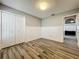 Bedroom featuring plank flooring, white trim, and a view into the living room at 998 Piedmont Oaks Dr, Apopka, FL 32703