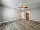 Bedroom featuring gray walls, plank flooring, a ceiling fan, and a view into the closet at 998 Piedmont Oaks Dr, Apopka, FL 32703