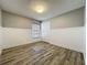 Well lit bedroom featuring plank flooring, white trim, neutral walls, and a double door closet at 998 Piedmont Oaks Dr, Apopka, FL 32703