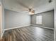 Spacious bedroom featuring a ceiling fan, plank flooring, and a window providing natural light at 998 Piedmont Oaks Dr, Apopka, FL 32703