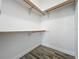 Walk-in closet with built-in shelving and wood-look tile floor at 998 Piedmont Oaks Dr, Apopka, FL 32703