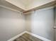 Walk-in closet featuring built-in shelving and wood-look flooring providing ample storage space at 998 Piedmont Oaks Dr, Apopka, FL 32703