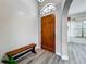 Bright entryway boasts brick accent wall, wood floors and front door with transom at 998 Piedmont Oaks Dr, Apopka, FL 32703