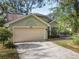 Well-maintained single-story home featuring a two-car garage, neat landscaping, and a large driveway at 998 Piedmont Oaks Dr, Apopka, FL 32703