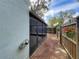 View of lanai from the backyard, framed by flowering hanging plants at 998 Piedmont Oaks Dr, Apopka, FL 32703