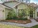 Charming home exterior featuring manicured landscaping, a bright window, and a welcoming entrance at 998 Piedmont Oaks Dr, Apopka, FL 32703