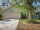 Well-maintained single-story home featuring a two-car garage, neat landscaping, and exterior lighting fixtures at 998 Piedmont Oaks Dr, Apopka, FL 32703