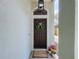 Inviting front entryway featuring a dark wood door with a decorative wreath and a welcoming 