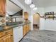 Bright kitchen featuring wood cabinets, stainless steel appliances, and an opening that leads to the living area at 998 Piedmont Oaks Dr, Apopka, FL 32703