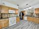 Updated kitchen with stainless steel appliances, wood cabinetry, and tile flooring at 998 Piedmont Oaks Dr, Apopka, FL 32703