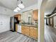 Well-lit kitchen features wood cabinets, stainless steel appliances, and tile floors at 998 Piedmont Oaks Dr, Apopka, FL 32703