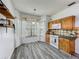Bright kitchen offers wood cabinets, stainless appliances, and breakfast nook at 998 Piedmont Oaks Dr, Apopka, FL 32703