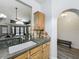 The kitchen features wooden cabinets, an undermount sink, and an opening that leads to the living area at 998 Piedmont Oaks Dr, Apopka, FL 32703
