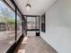 Enclosed lanai with tile flooring and views of the wooded backyard at 998 Piedmont Oaks Dr, Apopka, FL 32703