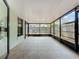 The covered lanai has a tile floor and is enclosed with black metal framing at 998 Piedmont Oaks Dr, Apopka, FL 32703