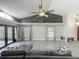Living room features vaulted ceiling, decorative shelves, and wood-look tile flooring at 998 Piedmont Oaks Dr, Apopka, FL 32703