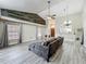 Open living room with wood-look tile, vaulted ceilings, and natural light at 998 Piedmont Oaks Dr, Apopka, FL 32703