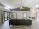 Bright living room boasts wood-look tile floors, a vaulted ceiling, and a large sliding glass door at 998 Piedmont Oaks Dr, Apopka, FL 32703