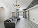 Bright living room offers vaulted ceilings, hardwood floors, a ceiling fan, and access to outdoor patio at 998 Piedmont Oaks Dr, Apopka, FL 32703