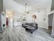 Inviting living room with modern decor, vaulted ceiling, and wood-look tile flooring at 998 Piedmont Oaks Dr, Apopka, FL 32703