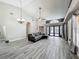 Spacious living room boasts vaulted ceilings, hardwood floors, a ceiling fan, and access to outdoor patio at 998 Piedmont Oaks Dr, Apopka, FL 32703