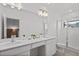 Bright, modern bathroom with double sinks, quartz countertops, a sleek glass-enclosed shower, and contemporary fixtures at 10436 Ebb Tide Lane, Orlando, FL 32821