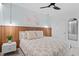 Tranquil bedroom featuring a decorative wood headboard, a modern ceiling fan, pendant lighting, and a minimalist design at 10436 Ebb Tide Lane, Orlando, FL 32821