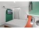 Modern bedroom with a queen-sized bed, green accent wall, and TV at 10436 Ebb Tide Lane, Orlando, FL 32821