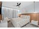 Serene bedroom featuring a decorative wood headboard, a modern ceiling fan, stylish light fixtures, and a cozy chair for relaxation at 10436 Ebb Tide Lane, Orlando, FL 32821