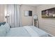 A calming bedroom features an ornate wall design, a decorative mirror, and a flatscreen television for comfortable relaxation at 10436 Ebb Tide Lane, Orlando, FL 32821