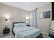 Charming bedroom with decorative wall panels, soft blue bedding, elegant lighting, and a decorative mirror, exuding a peaceful ambiance at 10436 Ebb Tide Lane, Orlando, FL 32821
