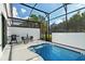Relaxing screened-in pool area with a table, chairs, and outdoor grill at 10436 Ebb Tide Lane, Orlando, FL 32821