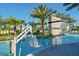 This accessible resort pool features a chair lift, a waterfall feature, a ladder, and mature palm trees at 10436 Ebb Tide Lane, Orlando, FL 32821