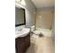 Bathroom featuring a vanity with a dark wood cabinet, shower/tub and tile flooring at 1055 S Hiawassee Rd # 2018, Orlando, FL 32835