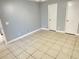 Empty bedroom with tile floor, neutral paint, two closets, and white trim at 1055 S Hiawassee Rd # 2018, Orlando, FL 32835