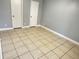 Empty bedroom with tile floor, neutral paint, two closets, and white trim at 1055 S Hiawassee Rd # 2018, Orlando, FL 32835