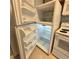 A clean, well-lit refrigerator with open shelves and white appliances next to it at 1055 S Hiawassee Rd # 2018, Orlando, FL 32835